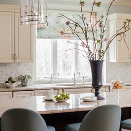 Transitional kitchen with carrara backsplash and blue leather counter stools