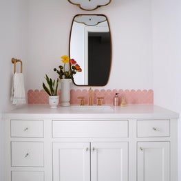 A pop of pink and a touch of brass creates a beautifully simple bathroom for our client's daughter.