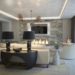 The matte black console table's curves contrast with angular table lamps.