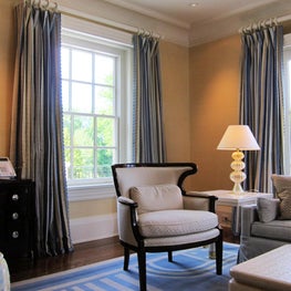 A quaint sitting room in this Pennsylvania home gets custom drapes as well as matching custom hardware.