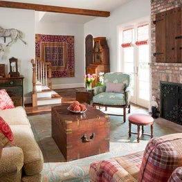 Casual family room displays antique carousel horses and antique quit as art