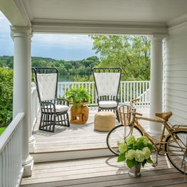 Porch with High Back Chairs, Gold Bicycle, and a Lake View