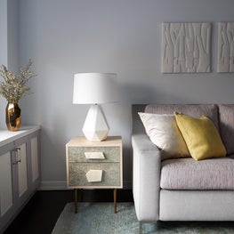 Upper East Side Family Room with two-tone sofa, angular lamp and colorful pillow