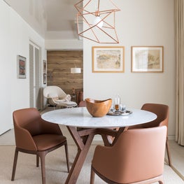 Portfolio: Indo-Asian Inspired High-Rise with warm-toned chairs and rose gold pendant light