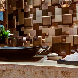 Installing three dimensional, padded wall tiles bring softness and dimension to the powder room 