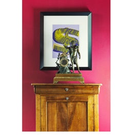 Original Andy Warhol hangs over a Louis-Phillippe secretary with hot pink wall