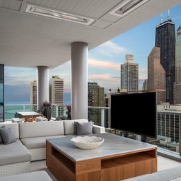 A city terrace with a custom coffee table and TV. 