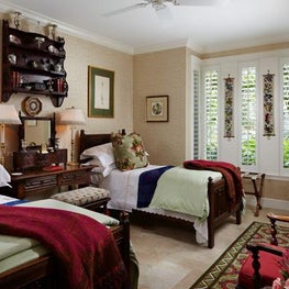Twin beds in this traditional guest room are joined by family heirlooms.
