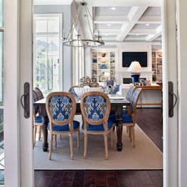 Inviting dining room with coastal blues blends seamlessly into the living room.