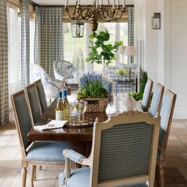 Contemporary farmhouse dining room with bronze chandelier