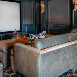 Portfolio: Modern styled media room featuring custom upholstered theater seats and Chivasso pillows.