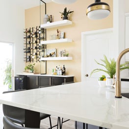 Black & White Kitchen with chic pendant lighting and polished brass finishes.
