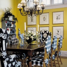 A timeless checkered fabric of blue and white balances the bold yellow walls.