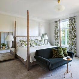 Bedroom with 4 post bed, neutral palette with printed drapes