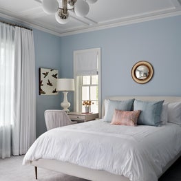 Natural light and a soft color palette reinforce a connection to nature to encourage wellbeing in this youth's bedroom.