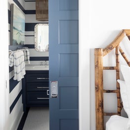 Striped wallpaper in a beach house bathroom