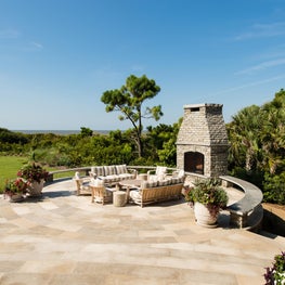 Oceanfront Circular Patio with Curved Stone Bench and Outdoor Fireplace