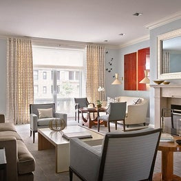 Clean lined traditional NYC Living Room, butterfly wall art, calming blue tones.