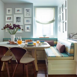 Upper East Side Breakfast nook with striped built-in banquette and gallery walls