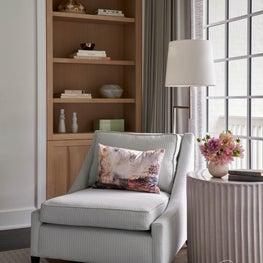Natural light, a vaulted ceiling, and a calming color scheme create an atmosphere of Zen in this primary bedroom.
