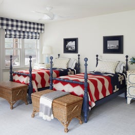 Lake Geneva Bedroom. Red, white & blue camp blankets on navy 4 poster beds with Buffalo check shades.