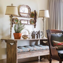 Antique bench turned to table with antique platters and Majolica 