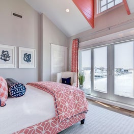 Coral and navy bedroom in a bayfront house 