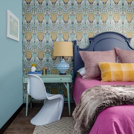 Arts and crafts Voysey wallpaper with kids desk in this family-friendly bedroom