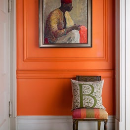 Entrance foyer with vibrant orange walls and mosaic floors