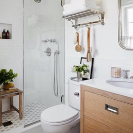 Contemporary bathroom with oak vanity and marble floors