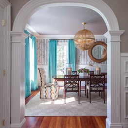 Entryway Foyer and Dining Room with Detailed Millwork and Globe Chandelier