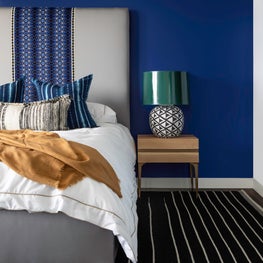 Portfolio: Colorful and Sophisticated Bedroom with Blue Walls and a Black Floor Covering