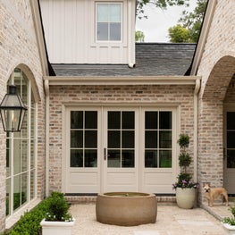 Equipped with a fireplace, outdoor kitchen, and plenty of seating, this covered loggia is the perfect, year-round entertaining space.