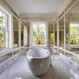 Classical serenity in a mirrored tub room with ocean views