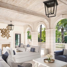 Carved limestone and bleached cypress details in a Palm Beach Loggia