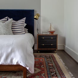 Portfolio: Modern and sophisticated bedroom with a blue headboard and white walls