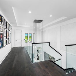 SLEEK CONTEMPORARY METALLIC RESIDENCE loft, gallery wall, modern art, dark hardwood floors, glass knee walls, glass staircase