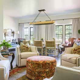 Sitting area with custom chairs, hunting prints and antique decanter collection