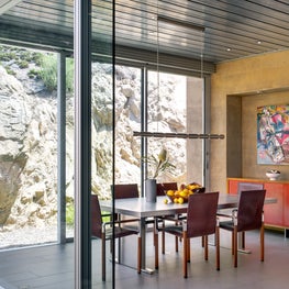 Dining room in contemporary glass, steel and concrete house.