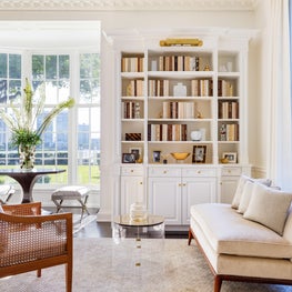 Classical Georgian motifs and a curved glass window facing the water.
