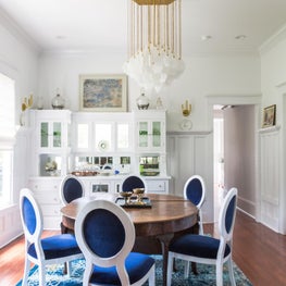 Dining room with custom velvet chairs and vintage dining table 