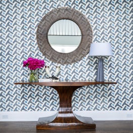 Entry Hall with Geometric Wall Covering, Sculptural Walnut Console, Brass Mirror