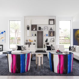 Portfolio: Contemporary living room with Andy Warhol artwork and bright accent chairs.