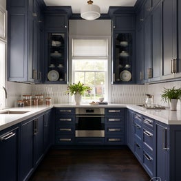 Dressed in a sophisticated shade of blue and adorned with mixed metals, the Colonial Drive butler’s pantry is as elegant as it is functional.