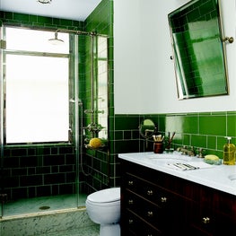 Master Bathroom in NYC apartment with green tiled walls 