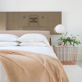 Modern bedroom, white with textural accents & smoky mirror headboard