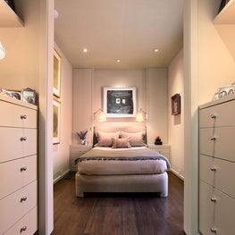 Warm neutral bedroom with walk-in closet and dressing area