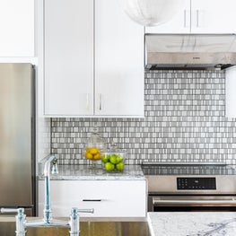 Custom Kitchen cabinetry with mosaic splash detail 