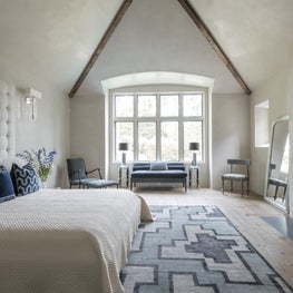 Luxury master suite with blue + white accents & wood beams; Houston, TX