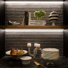 Graphic lighting and mosaic tile in a pantry niche in a Park Avenue kitchen